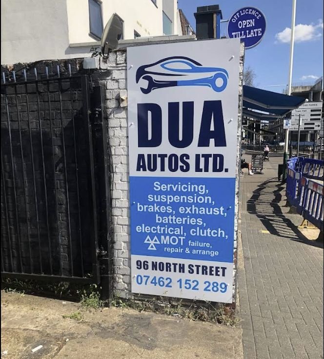 The Dua Autos sign on North Street listing servicing, suspension, brakes, exhaust, batteries, electrical, clutch and MOT failure repair